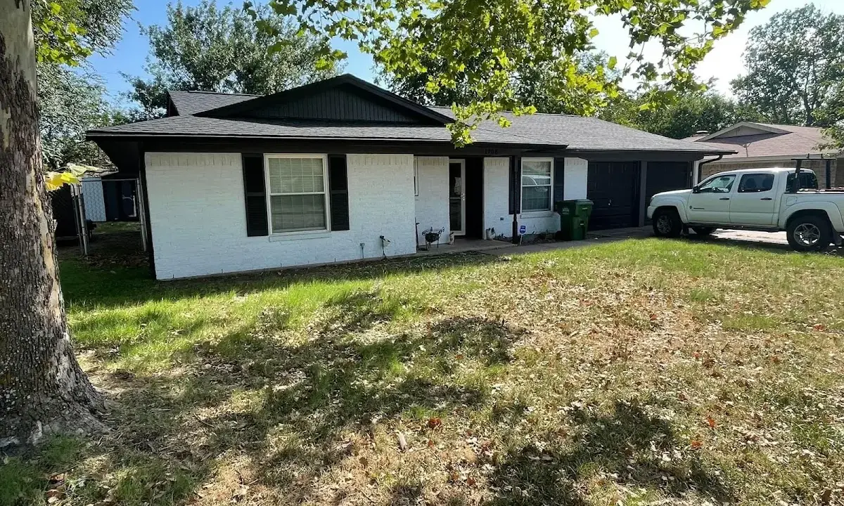 Professional roofing crew working on a residential roof in Anoka